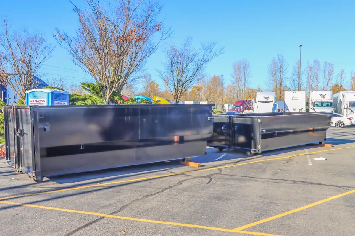 Professional dumpster rental service with roll-off container on residential driveway in Smithtown